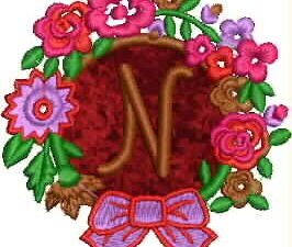 Elegant machine embroidery design featuring a large script letter "N" centered in a vibrant floral wreath of pink, purple, and red roses with green leaves, accented by a purple bow at the bottom.
