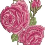 Romantic machine embroidery design featuring two large layered pink roses in full bloom, a smaller pink hibiscus-like flower above, a pink rosebud to the side, and textured green leaves on curving stems.